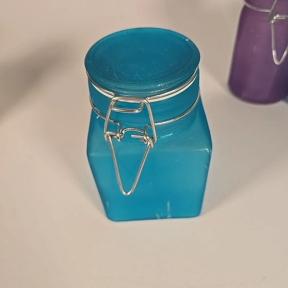 Set Of Four Colored‎ Glass Cannisters With Locking Tops Very Good Condition